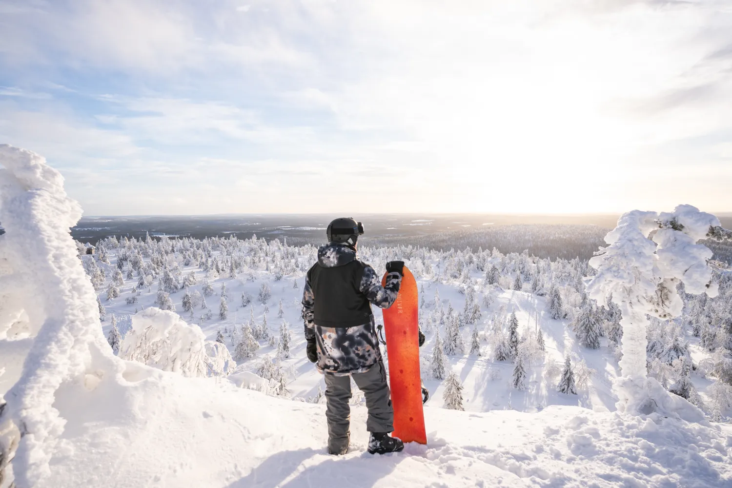 Huipulla lumilautailija